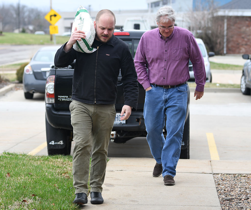 Lee Sensinataffar, left, carries a bag